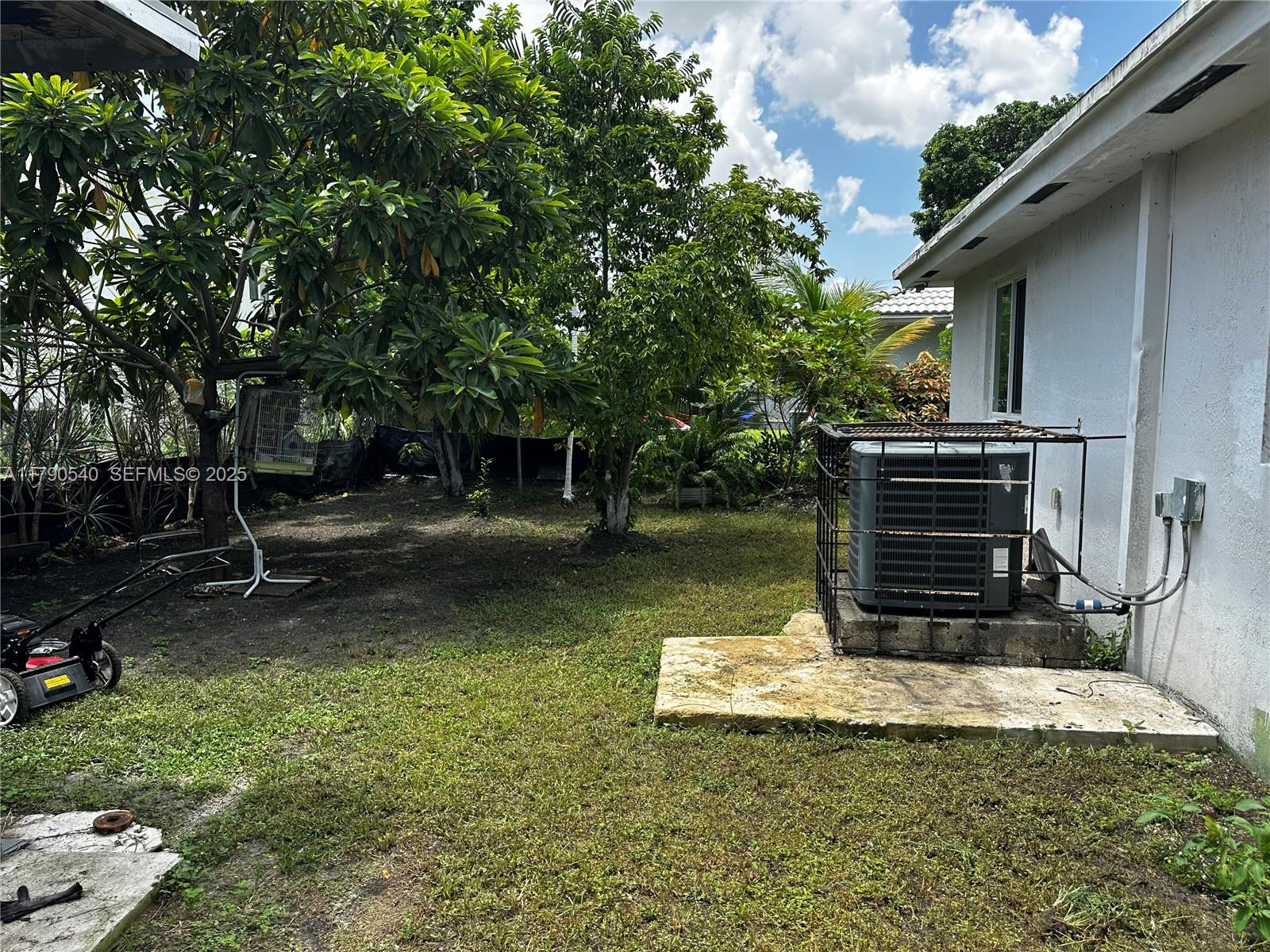 1446 Northwest 61st Street Miami, FL 33142 - Photo 37 of 54 a view of a small house with a yard