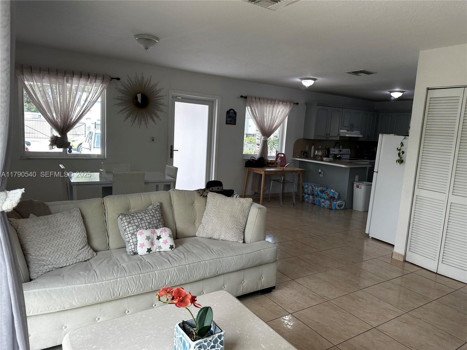 1446 Northwest 61st Street Miami, FL 33142 - Photo 42 of 54 a living room with furniture and a large window