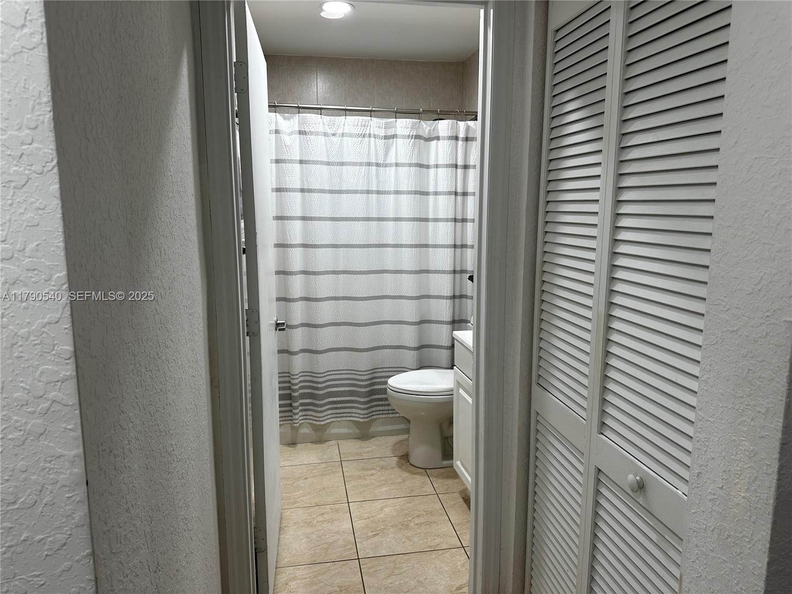 1446 Northwest 61st Street Miami, FL 33142 - Photo 45 of 54 a bathroom with a toilet and a shower