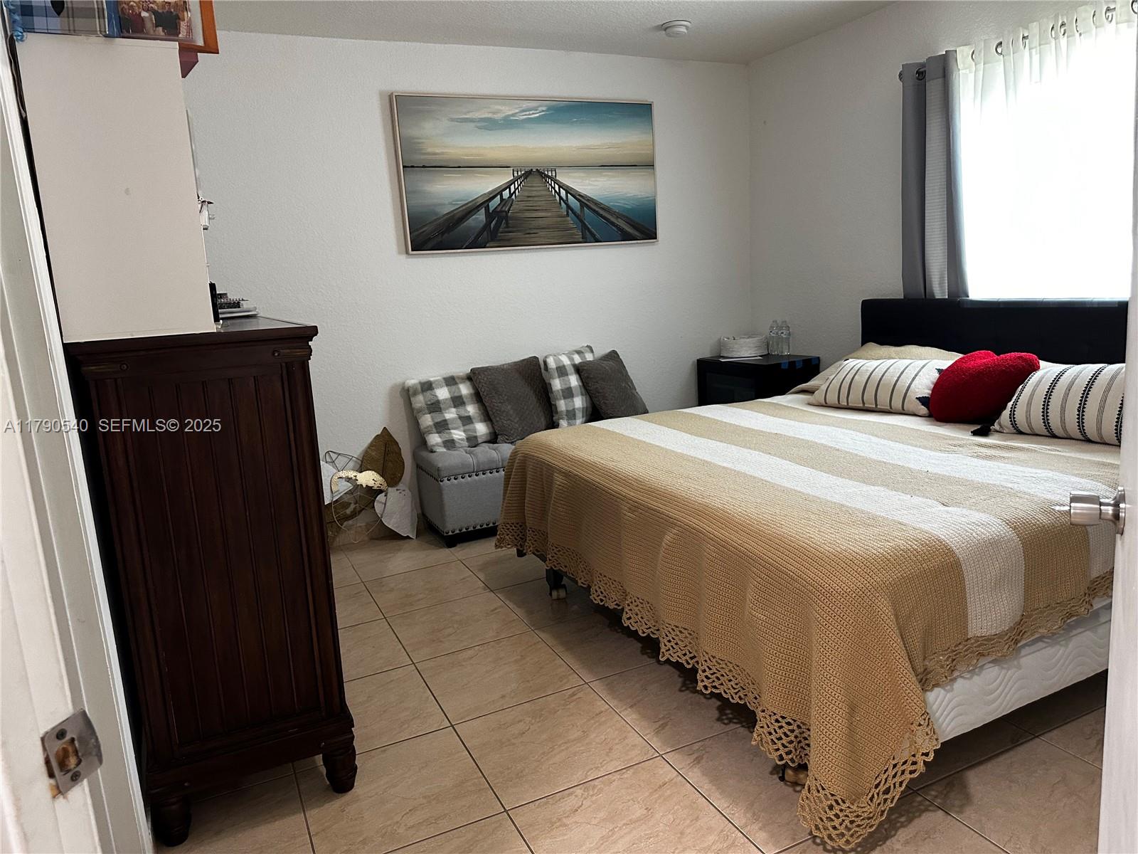 1446 Northwest 61st Street Miami, FL 33142 - Photo 46 of 54 a bedroom with a bed and a window