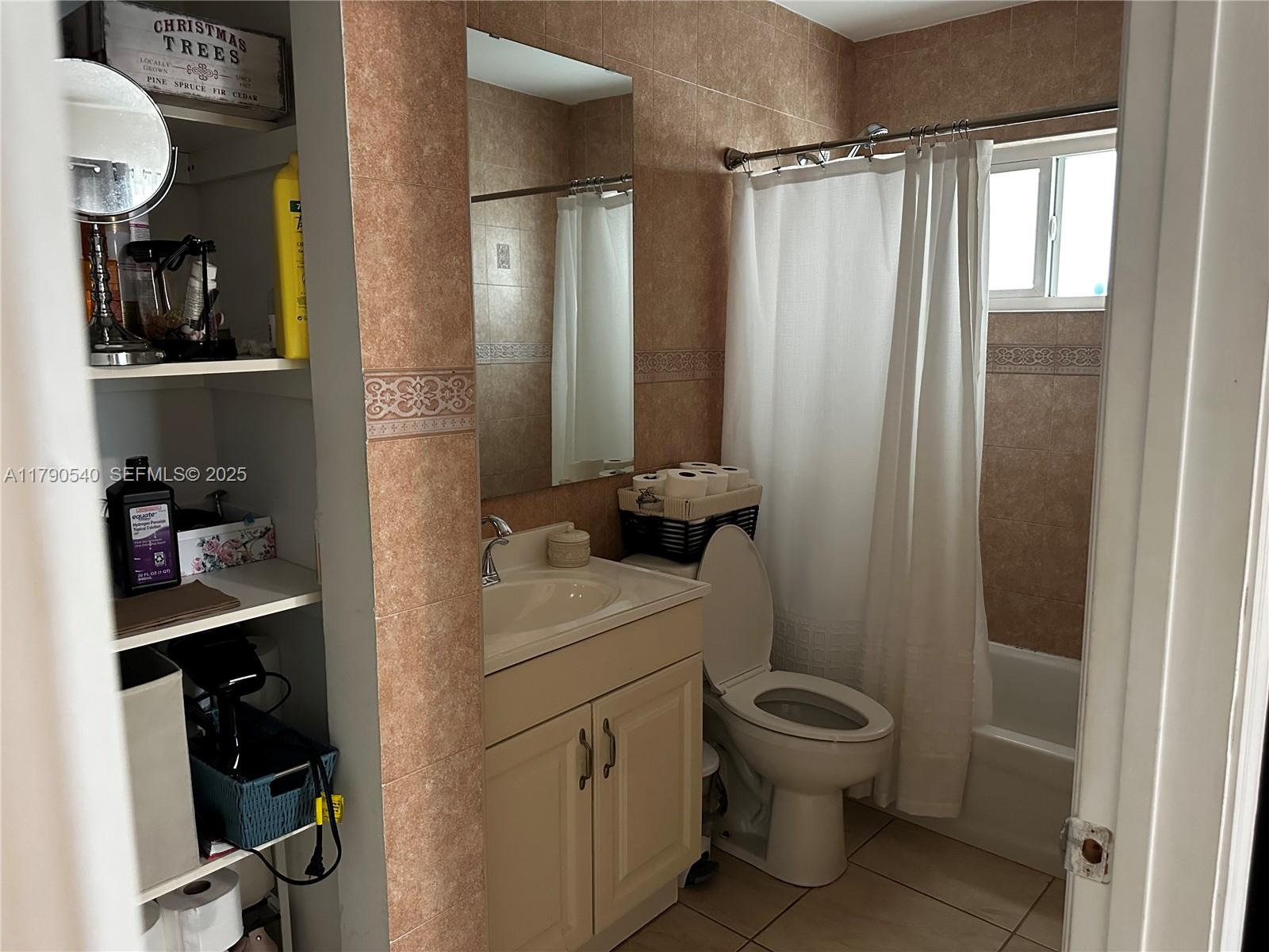 1446 Northwest 61st Street Miami, FL 33142 - Photo 47 of 54 a bathroom with a toilet a sink and a shower