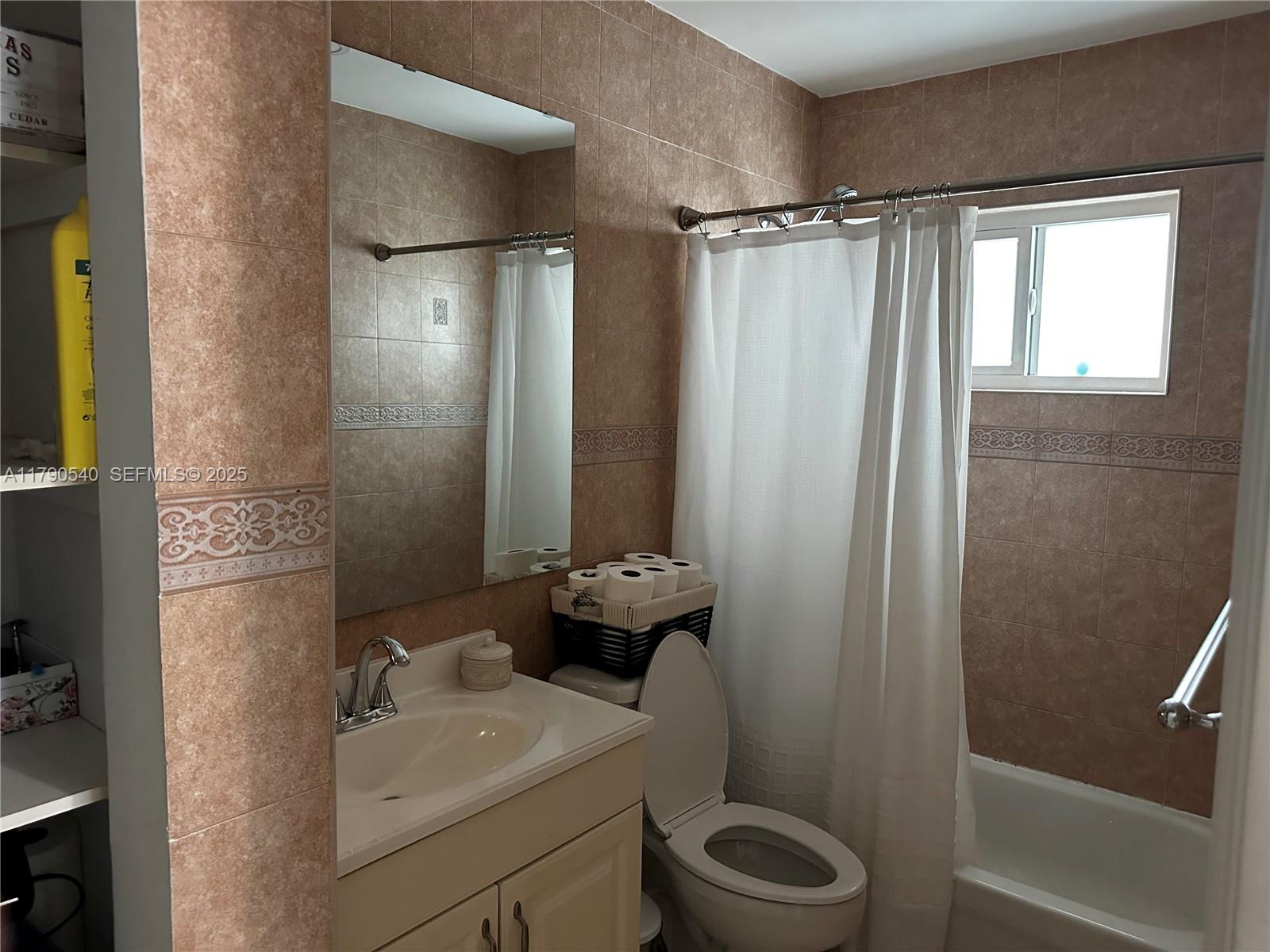 1446 Northwest 61st Street Miami, FL 33142 - Photo 48 of 54 a bathroom with a sink toilet and shower