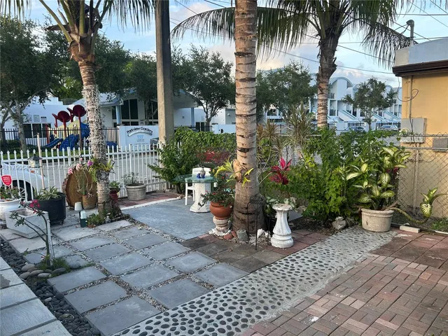 a view of a patio with table and chairs and potted plants