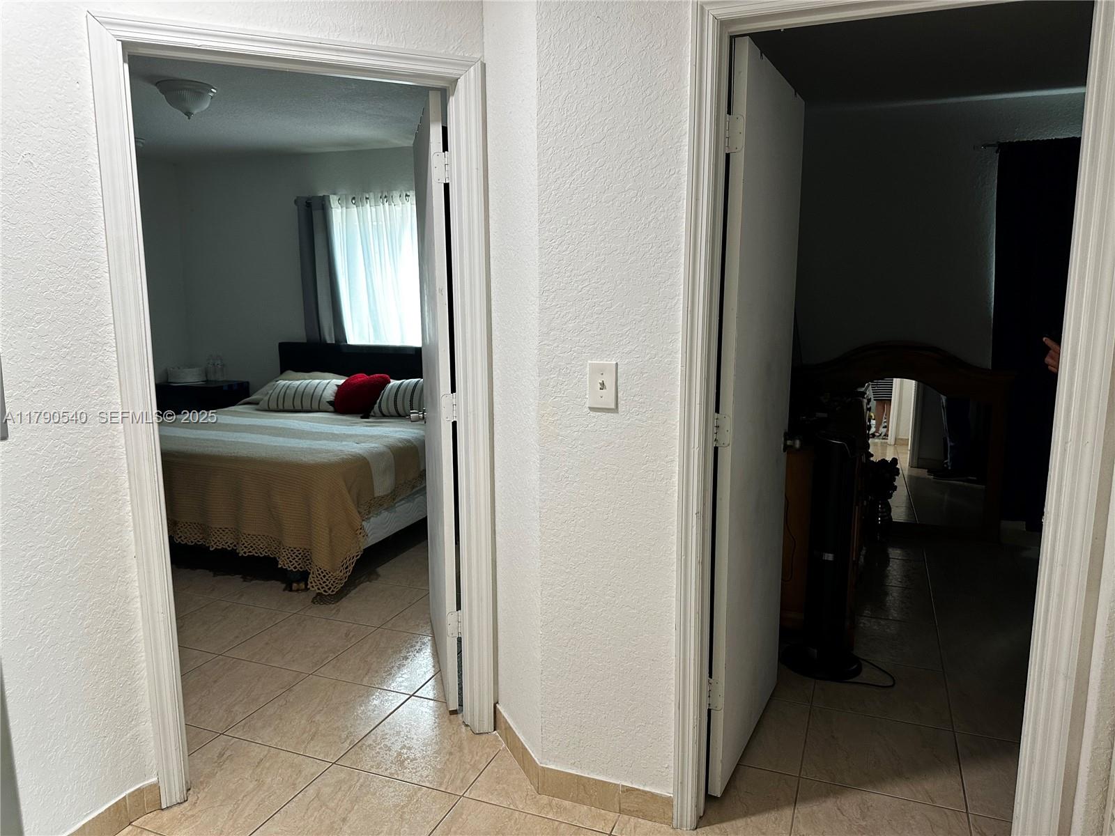 1446 Northwest 61st Street Miami, FL 33142 - Photo 54 of 54 a bedroom with a bed and a mirror