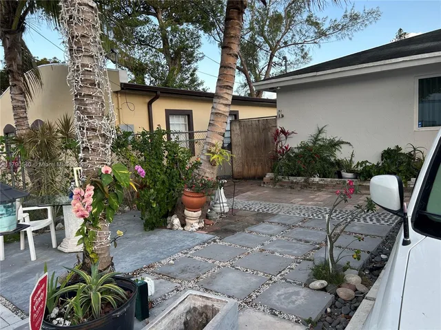 a backyard of a house with outdoor seating