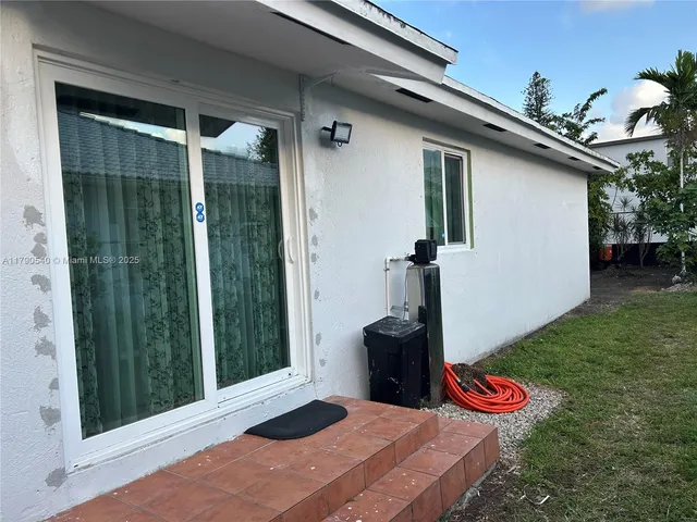 a table and chair in front of a house