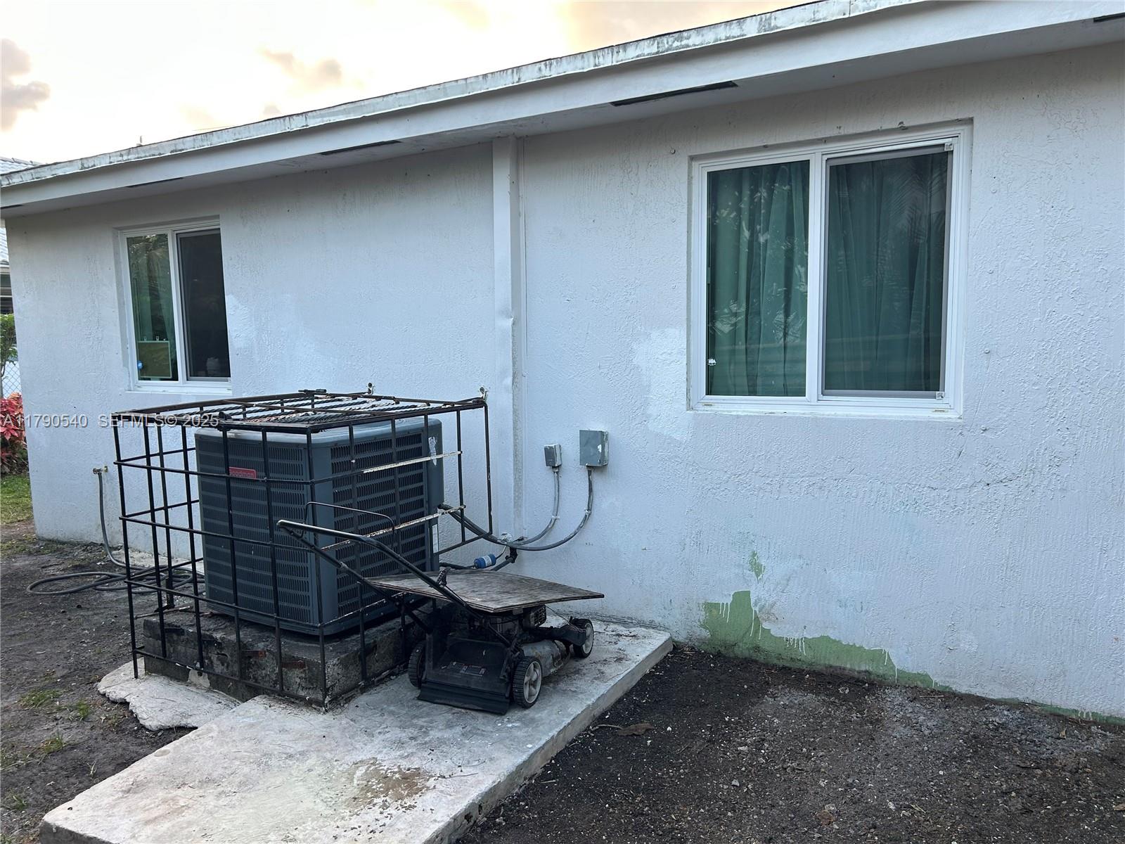 1446 Northwest 61st Street Miami, FL 33142 - Photo 9 of 54 a table and chair in front of a house