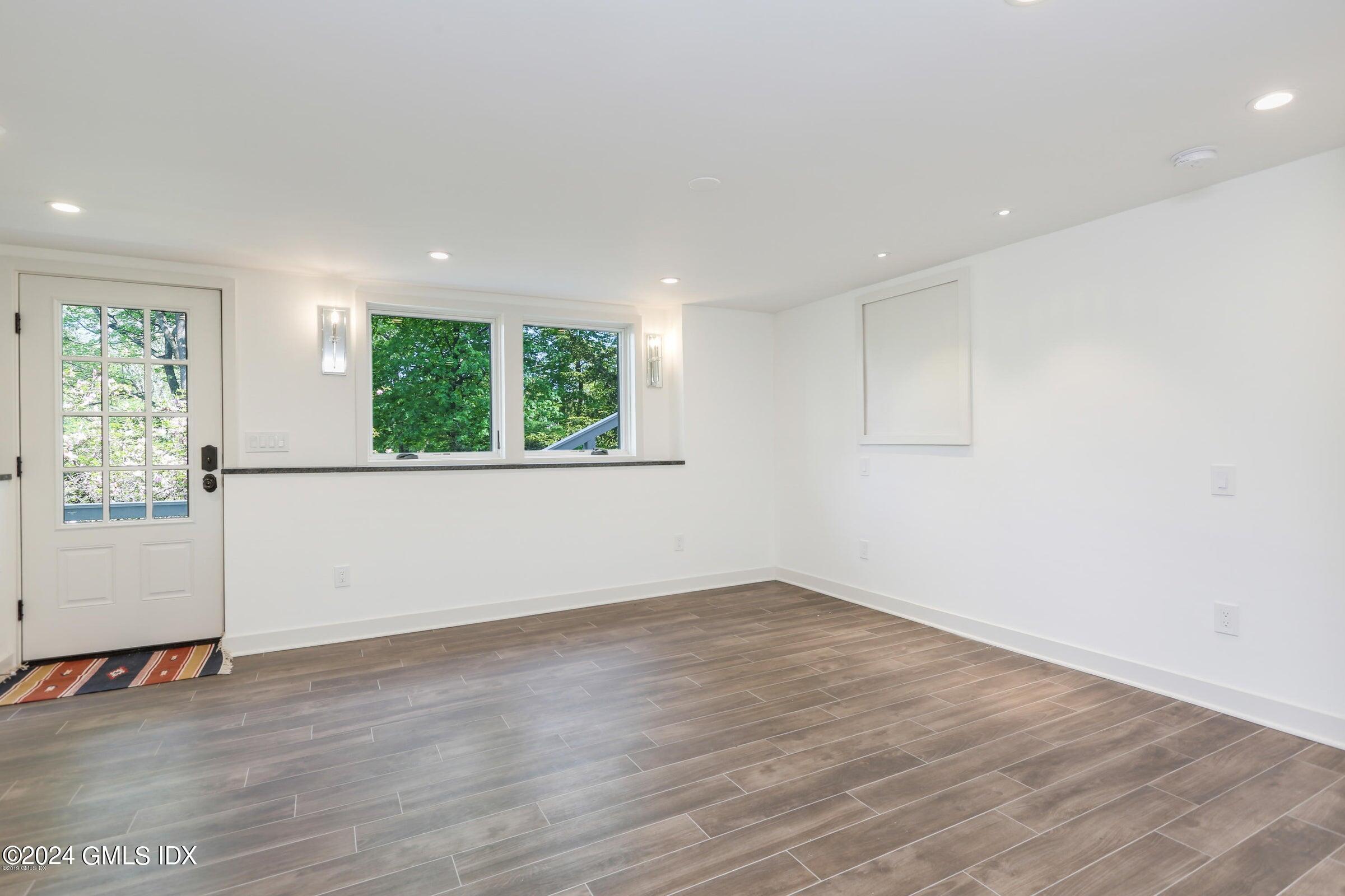 20 Martin Dale Greenwich, CT 06830 - Photo 14 of 25 an empty room with wooden floor and windows