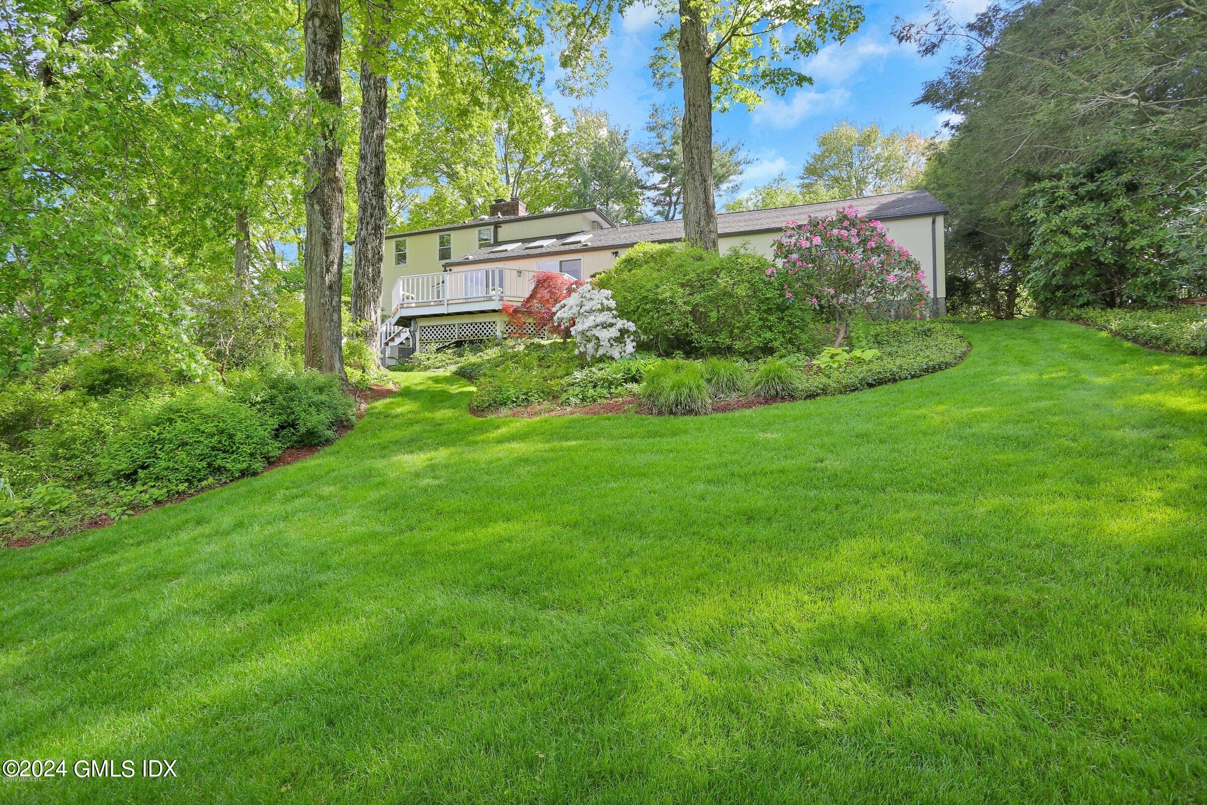 20 Martin Dale Greenwich, CT 06830 - Photo 19 of 25 a view of a backyard with potted plants and large trees