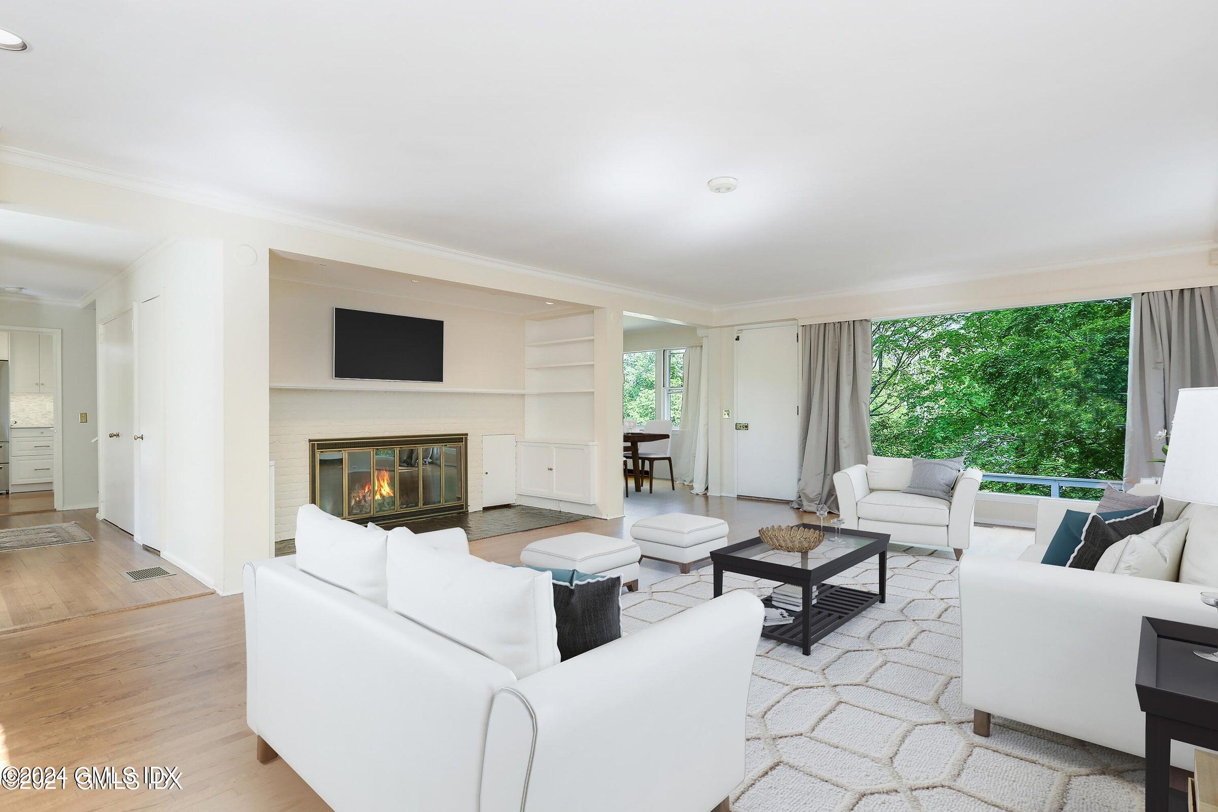 20 Martin Dale Greenwich, CT 06830 - Photo 2 of 25 a living room with furniture a fireplace and a flat screen tv