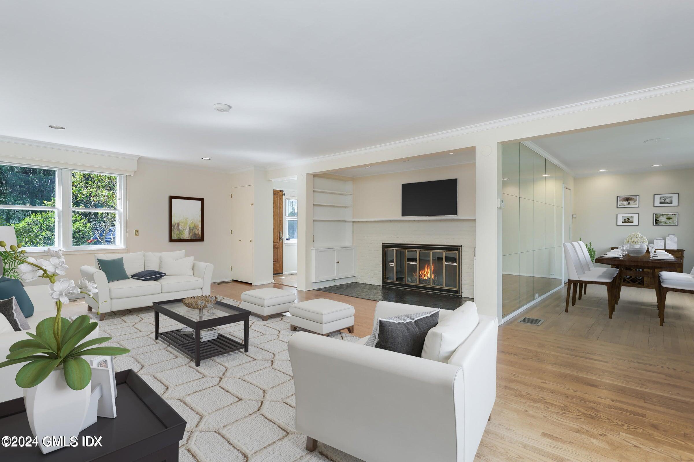 20 Martin Dale Greenwich, CT 06830 - Photo 3 of 25 a living room with furniture potted plant a fireplace and a window