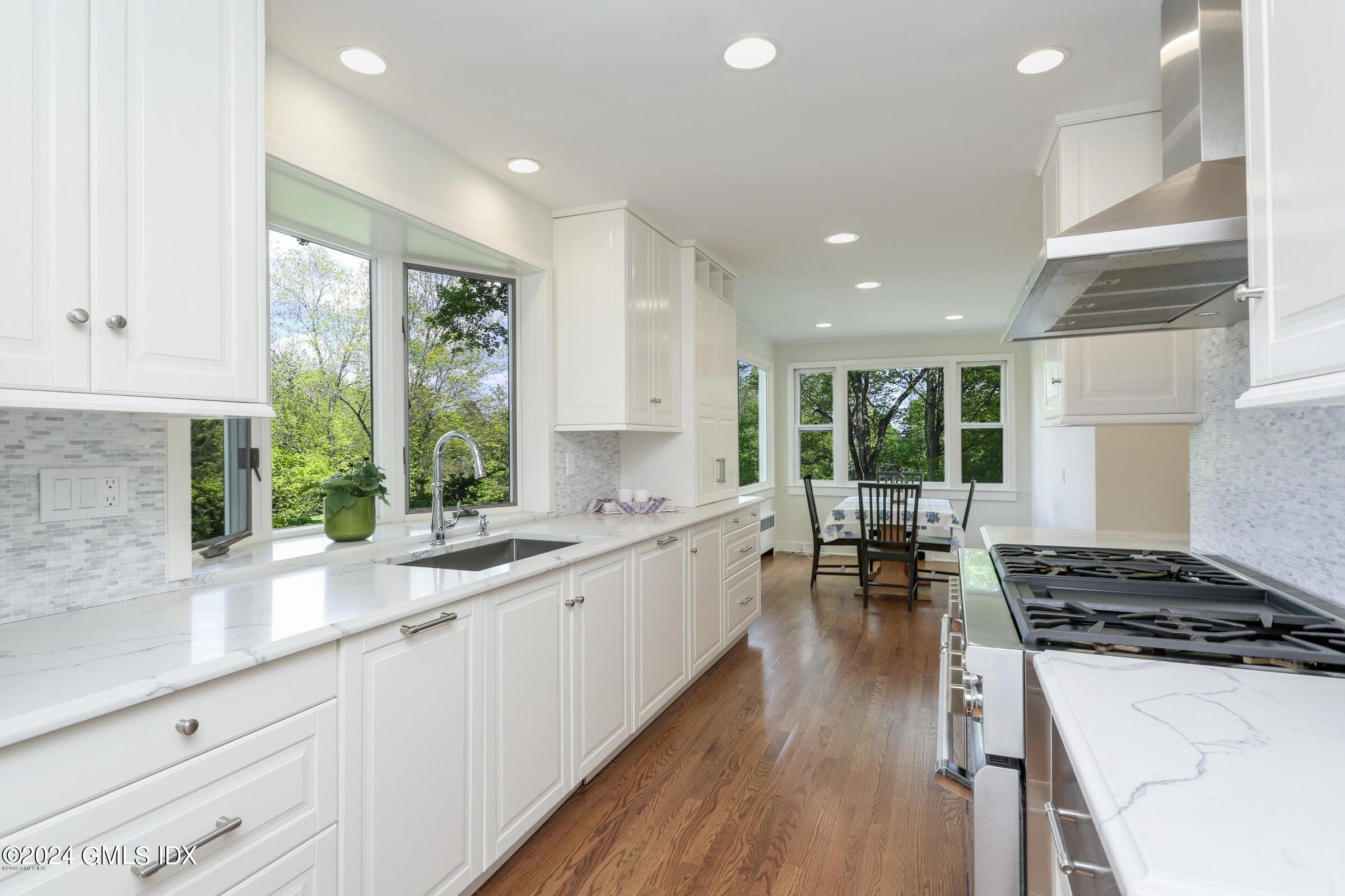 20 Martin Dale Greenwich, CT 06830 - Photo 6 of 25 a large kitchen with lots of counter top space a sink stainless steel appliances and cabinets