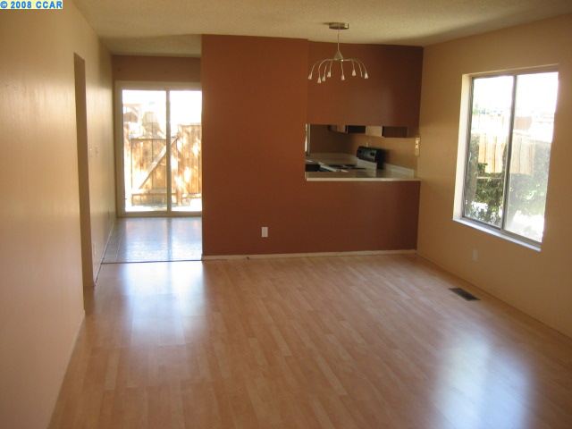 3806 Willow Pass Road, Unit E Concord, CA 94519 - Photo 1 of 1 a view of an empty room with wooden floor and a window