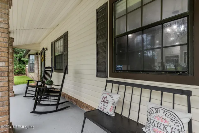 a dining room with wooden floor a chandelier a wooden table and chairs