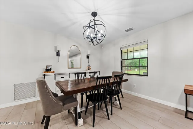 a kitchen with refrigerator and table
