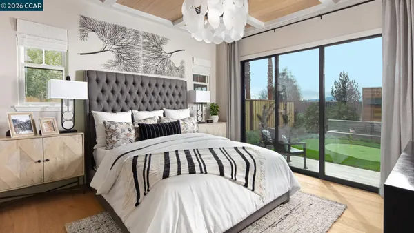 a bedroom with bed and a large window