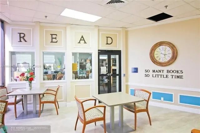 a dining room with furniture and a flat screen tv