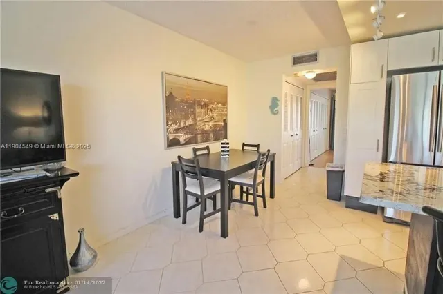 a dining room with furniture a table and chairs