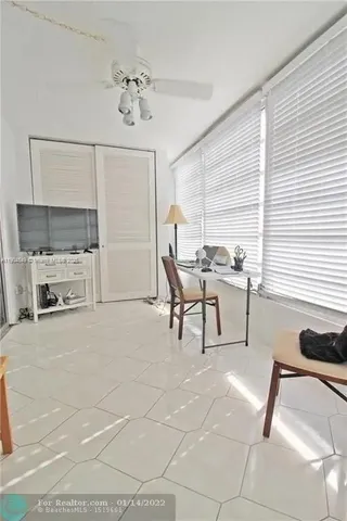 a dining room with lots of chairs and chandelier