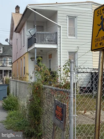 a front view of a house with plants