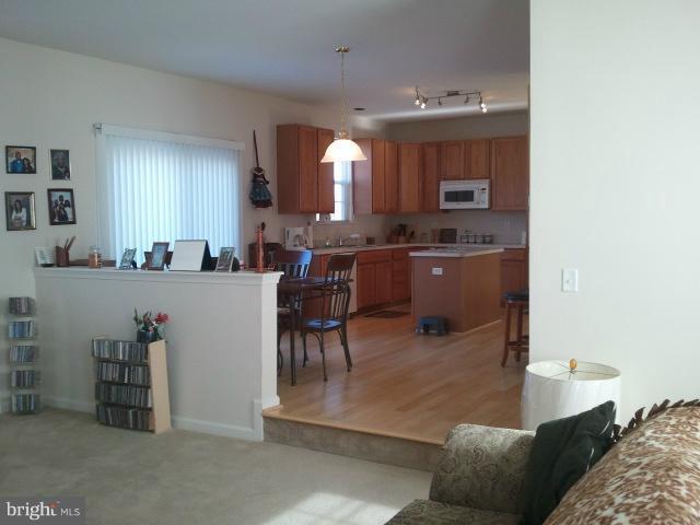 84 Boise Road Inwood, WV 25428 - Photo 23 of 30 a living room with furniture a dining table and kitchen view