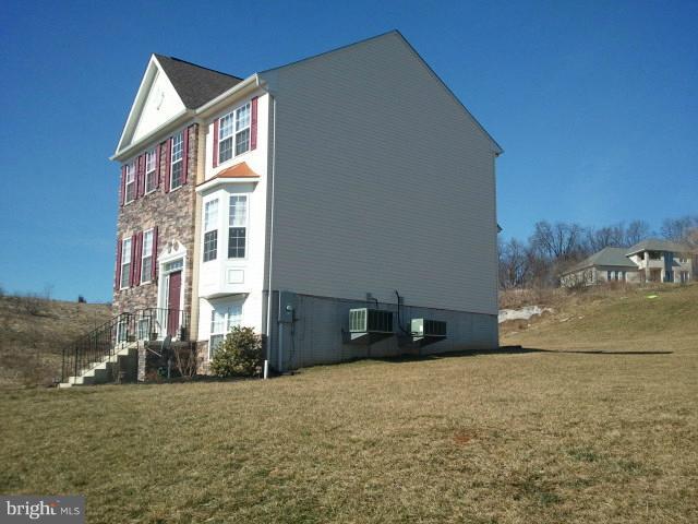 84 Boise Road Inwood, WV 25428 - Photo 10 of 30 a front view of a house with a yard