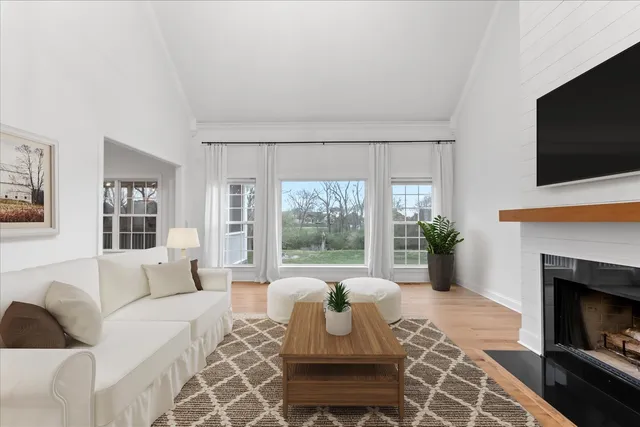 a kitchen with stainless steel appliances a sink a stove a refrigerator and island with wooden floor