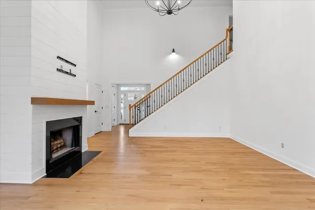 a kitchen with stainless steel appliances kitchen island granite countertop a sink a stove and a wooden floors