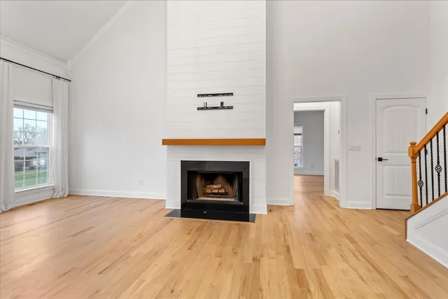 an entryway with fireplace a chandelier and wooden floor
