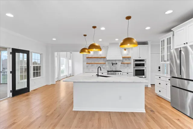 a kitchen with white cabinets and a stove