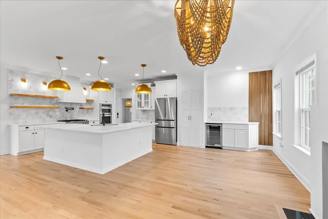 a living room with furniture fireplace and a large window