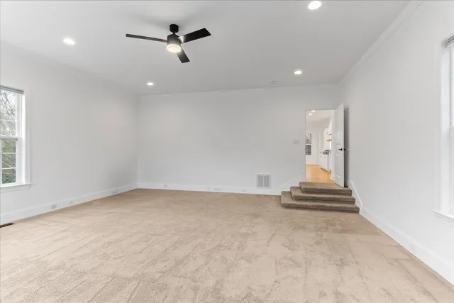a view of room with wooden floor and white walls