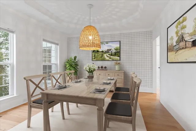 a view of an empty room with wooden floor fireplace and a window