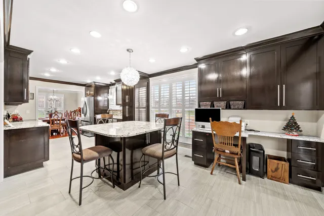 a kitchen with lots of counter top space cabinets and stainless steel appliances