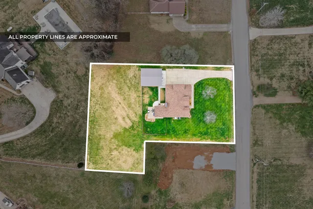 an aerial view of a house with garden space and lake view