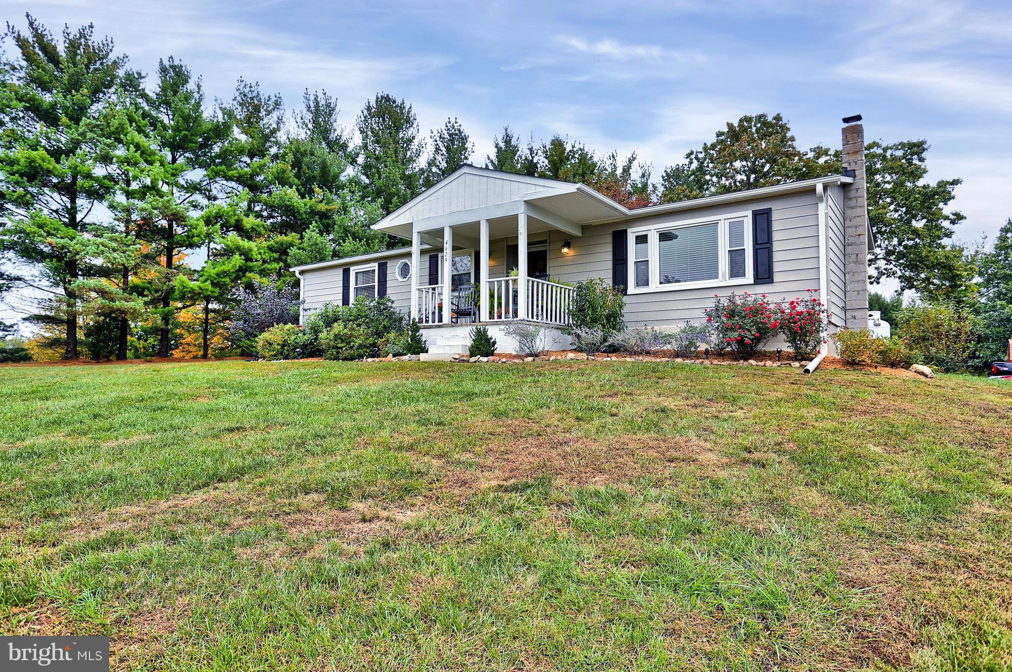 4629 Water Tank Road Manchester, MD 21102 - Photo 1 of 28 a front view of a house with a yard