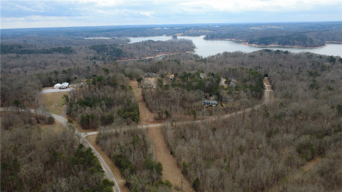 434 Rock Hill Road Fair Play, SC 29643 - Photo 6 of 11 This elevated view captures the extensive land featuring abundant trees, roads, and a beautiful lake.