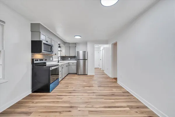 a kitchen with stainless steel appliances granite countertop a refrigerator sink and stove