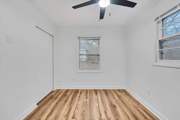 wooden floor in an empty room with a window