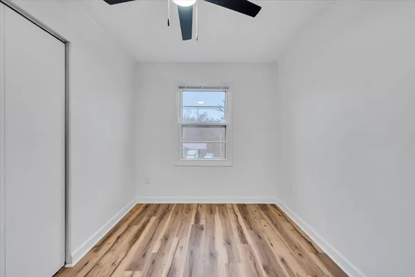 a view of room with window and ceiling fan