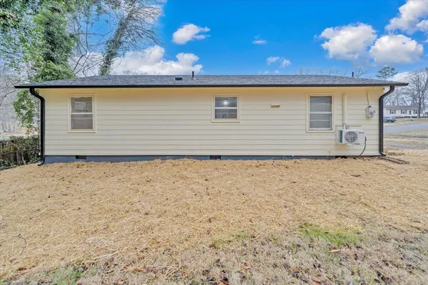 a view of house with backyard