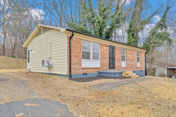 a view of a house with a yard and sitting area