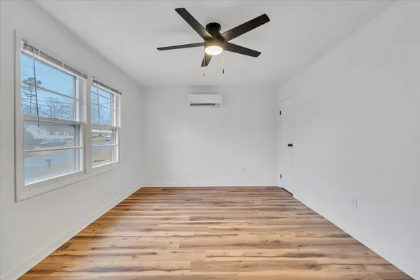 wooden floor in an empty room with a window
