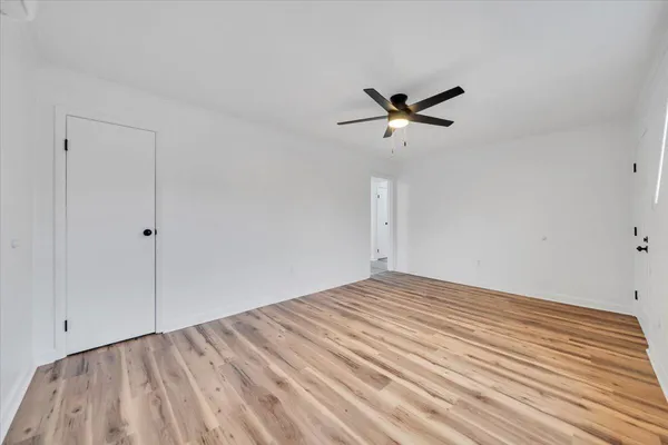 a view of a room with a ceiling fan