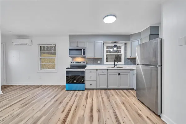 a kitchen with a refrigerator stove and sink