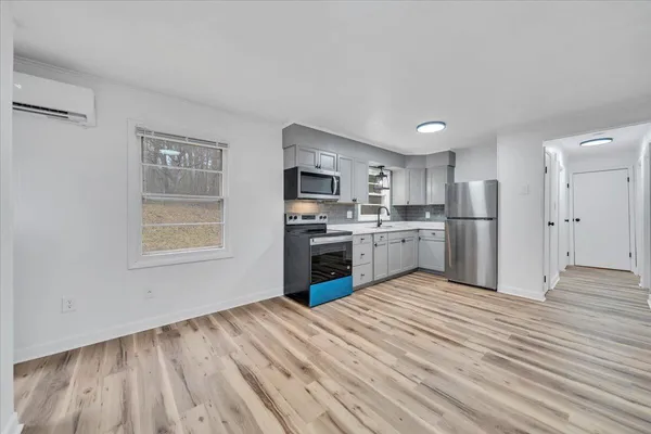 a kitchen with stainless steel appliances granite countertop a refrigerator sink and stove