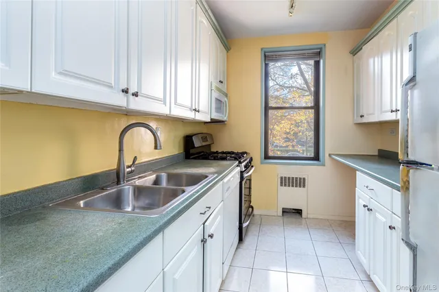 a kitchen with a sink cabinets and window