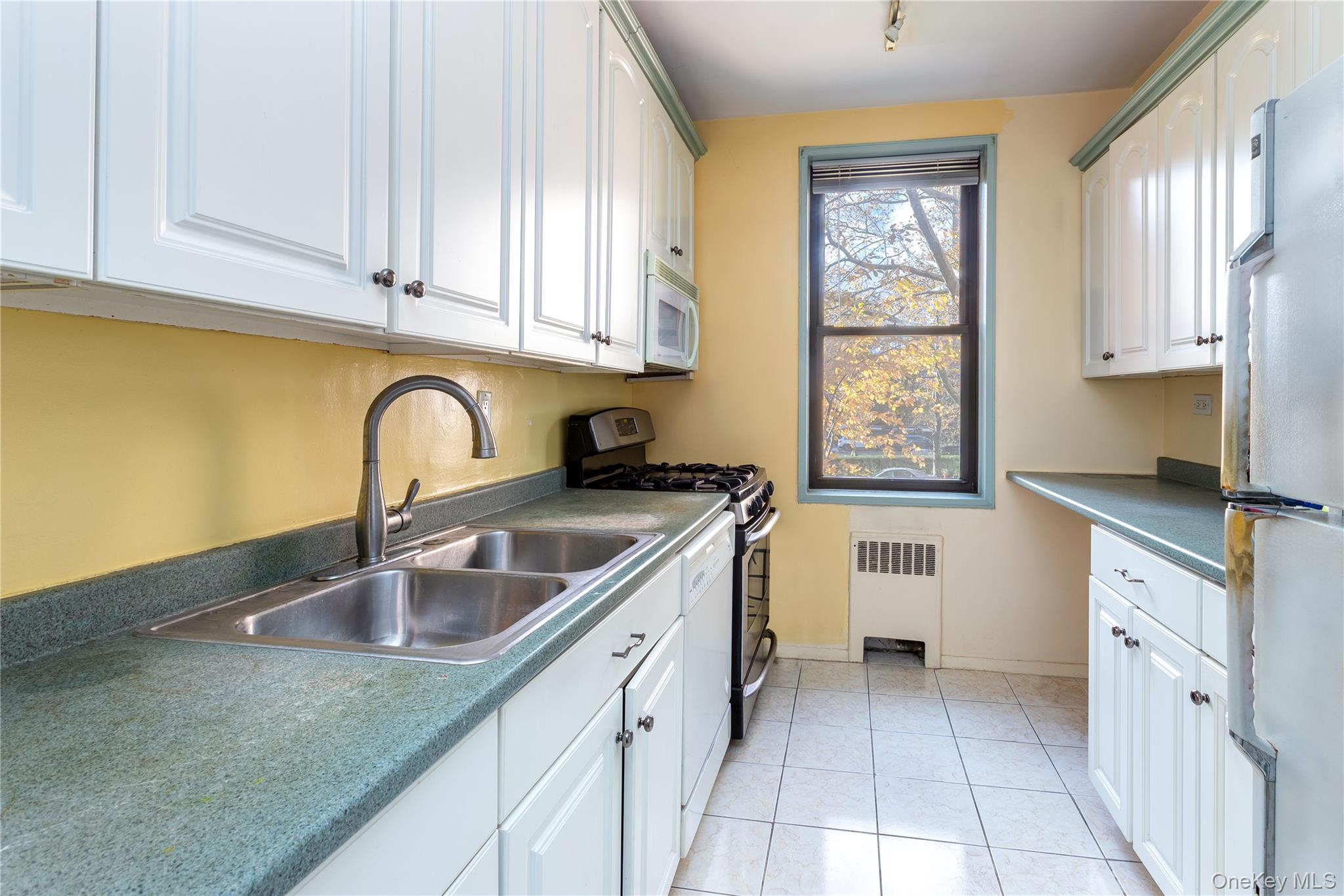 611 West 239th Street, Unit 3F Bronx, NY 10463 - Photo 3 of 12 a kitchen with a sink cabinets and window