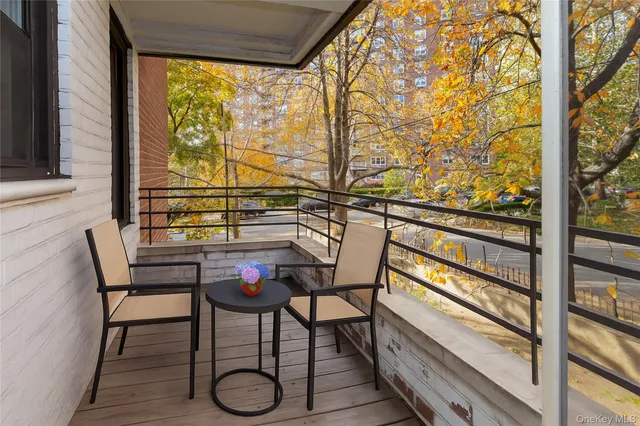 a view of a chairs and table in the balcony