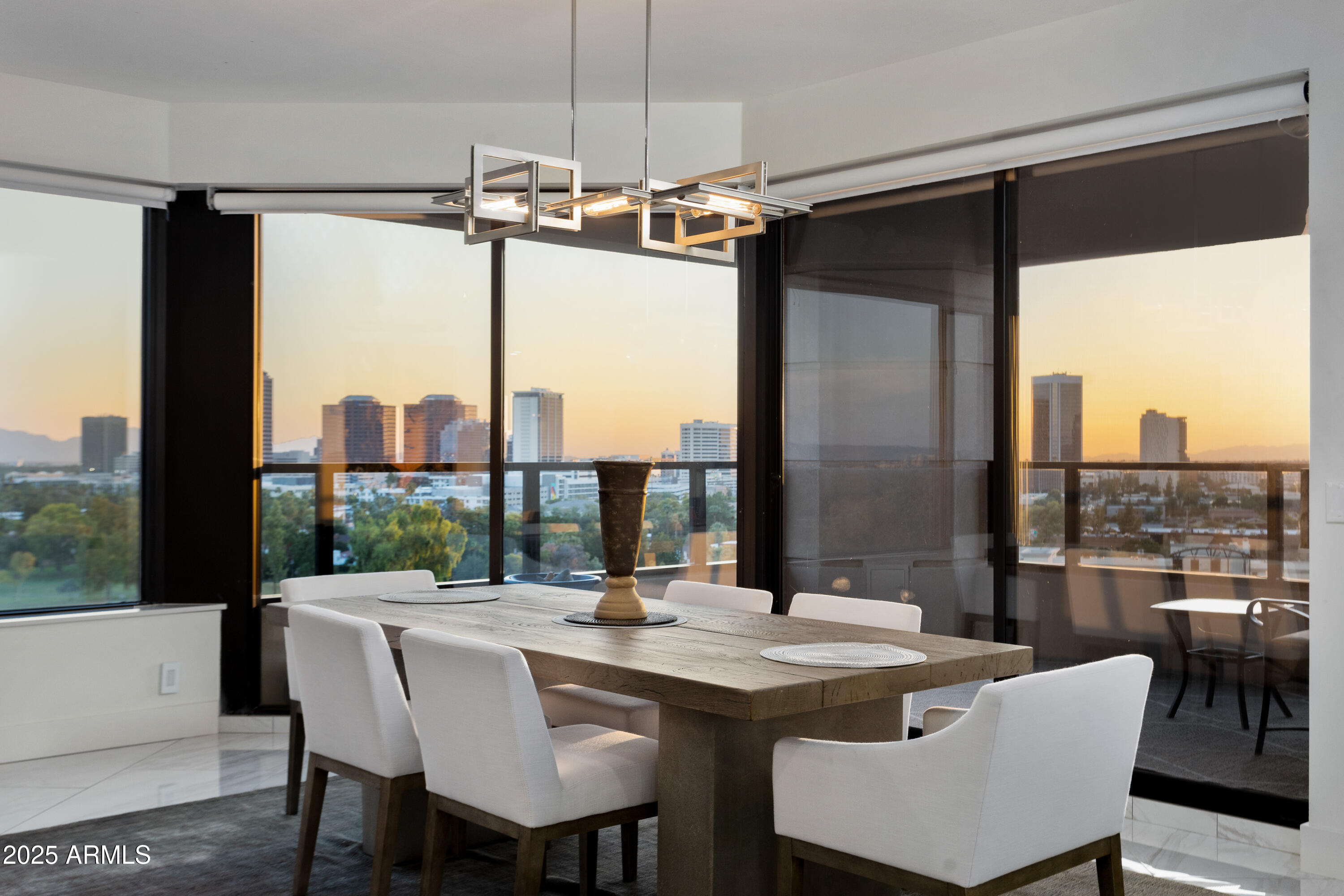 1040 East Osborn Road, Unit 904 Phoenix, AZ 85014 - Photo 4 of 22 a dining table with chairs and window